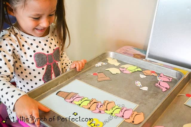 Preschooler counting the ice cream scoops in this Letter I Activity
