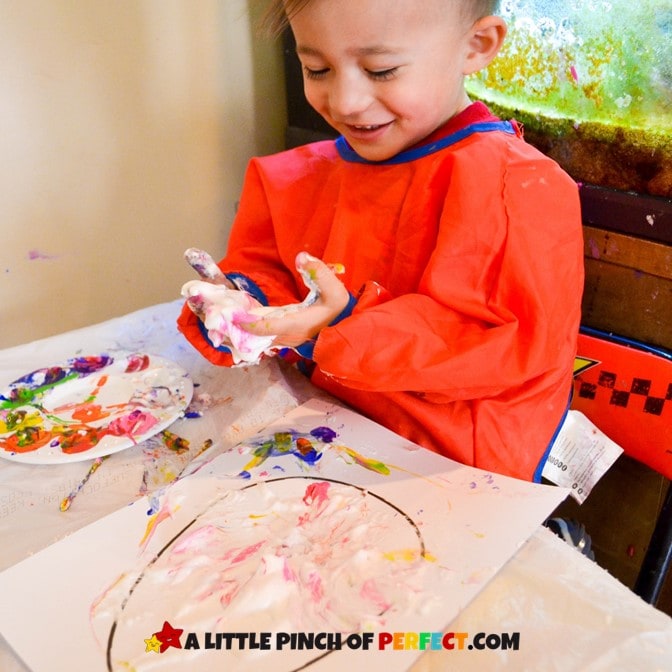 Little boy painting a Puffy Paint Easter Egg Craft for Kids + Free Template #eastercraft #easteregg #kidsactivity