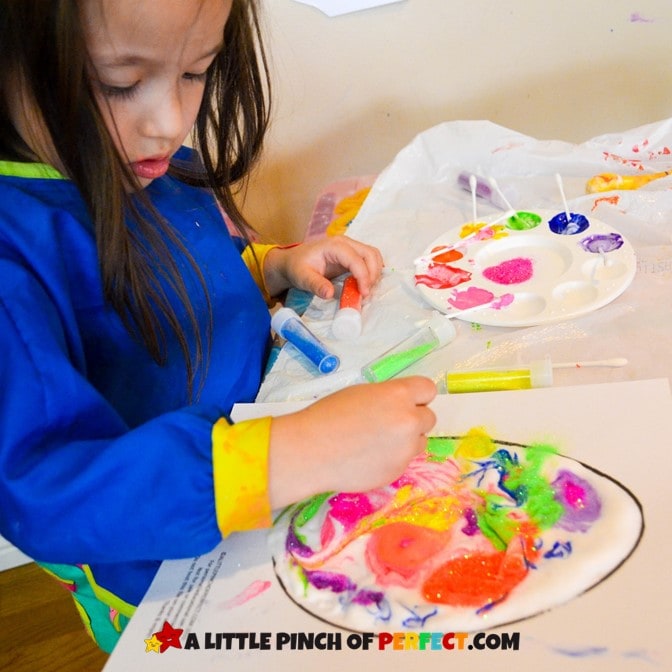 Little girl painting a Puffy Paint Easter Egg Craft for Kids + Free Template #eastercraft #easteregg #kidsactivity