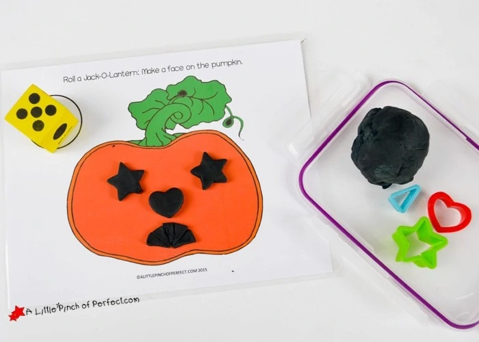 Roll a Jack O’ Lantern Halloween Playdough Game for Kids (Free Printable)
