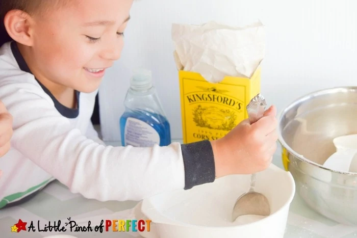 How to make Pretend Snow: Winter Themed Kinetic Sand Sensory Play for Kids that can be used to build snowmen, snow angels, and cool winter creations without getting cold. (December, January, Kids Activity)