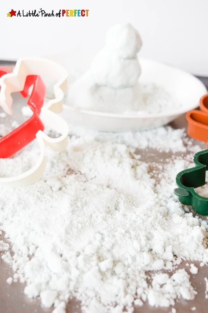 How to make Pretend Snow: Winter Themed Kinetic Sand Sensory Play for Kids that can be used to build snowmen, snow angels, and cool winter creations without getting cold. (December, January, Kids Activity)