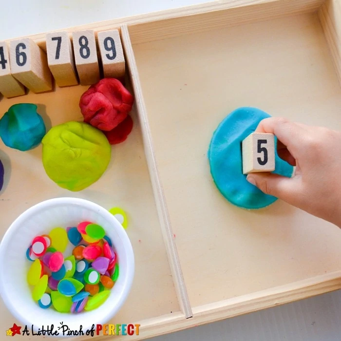 Easter Egg Stamp and Count Playdough Math: Children can decorate Easter eggs as they work on one-to-one correspondence, fine motor skills, and number recognition. (#math #preschool #easteractivity #easteregg)