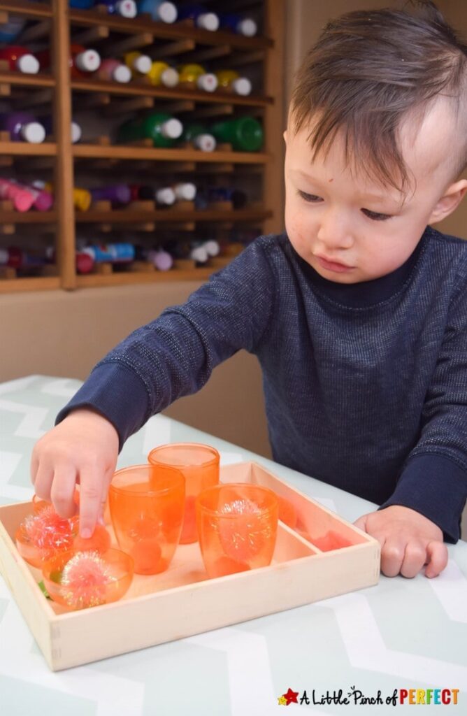 Kids will have so much fun with plastic carrots and puff balls! This engaging activity can be adapted for young children of all ages including ideas for your baby, toddler, and preschooler. #easter #kidsactivity #finemotor