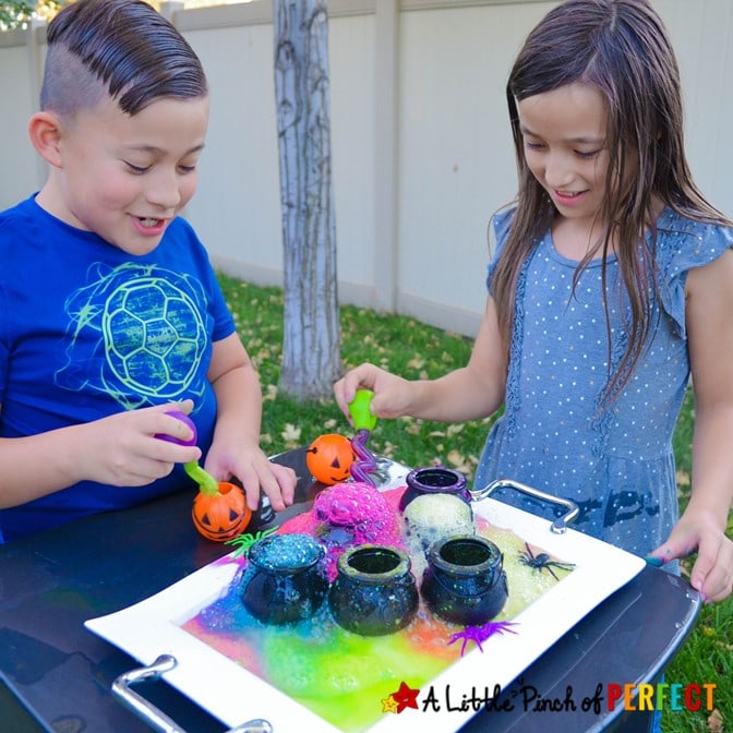 Kids doing colorful Witches Brew Science Experiment