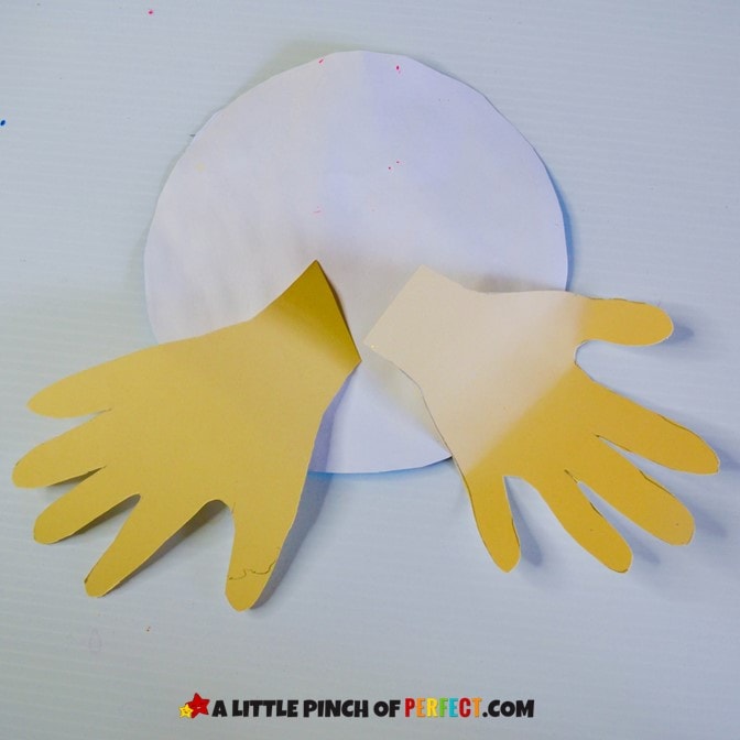 Attaching handprints to earth day craft #kidsactivity #earthday #preschool