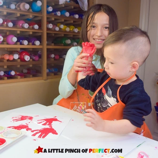 Sister and brother making a handprint flower craft together #kidsactivity #kidscraft #craft