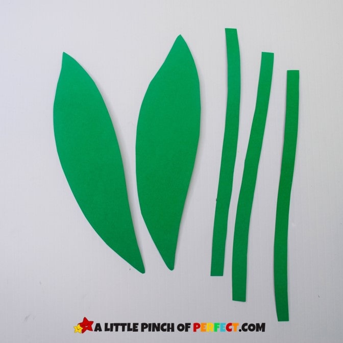 Green paper stems and leaves for handprint flower craft. #kidscraft 