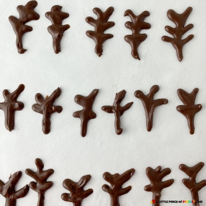 Piping Chocolate to make Reindeer Anters for S'mores Reindeer Cake Jar