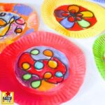 This easy stained glass-inspired suncatcher craft uses yarn, paint, and a paper plate to create a colorful window decoration kids will love.