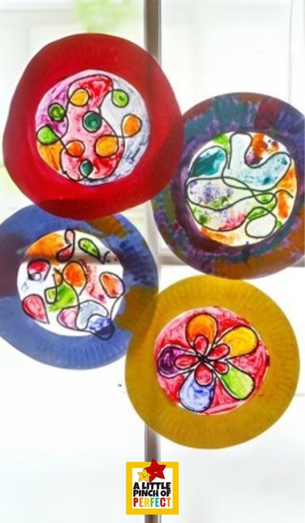 This easy stained glass-inspired suncatcher craft uses yarn, paint, and a paper plate to create a colorful window decoration kids will love.