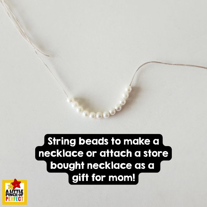 To make this craft even more special, kids can create a one-of-a-kind necklace to attach to the card! Simply string beads, buttons, or even colorful pasta onto a piece of thread or yarn to design a mini necklace that&rsquo;s as unique as Mom.