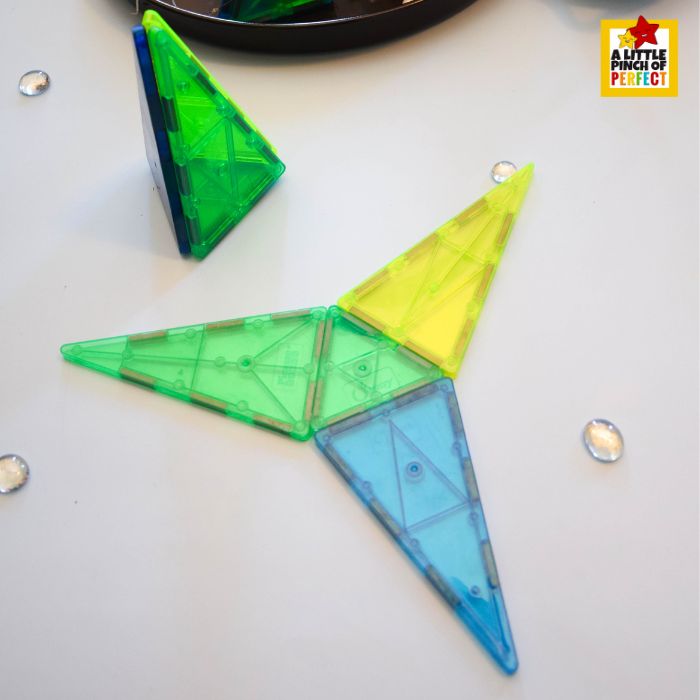 Magna-Tiles arranged in a pyramid to form a Christmas tree structure