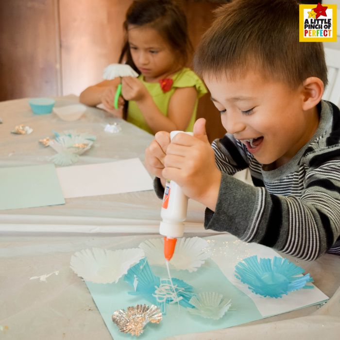 Snowflake Craft for Kids: Kids creating winter snowflake crafts with cupcake liners