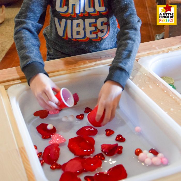 Love Potion Pour & Play Valentine Sensory Bin with pouring tools, hearts, and petals, perfect for preschoolers