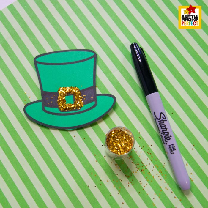 Coffee Filter Rainbow Leprechaun Craft for St. Patrick&rsquo;s Day (+ Hat Template) decorating the hat with marker and glitter