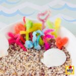 Borax Crystal Coral Reef Craft for Kids (Easy Ocean STEM Activity) collection of colorful crystal coral pieces created with pipe cleaners and Borax for an easy STEM craft and ocean activity.