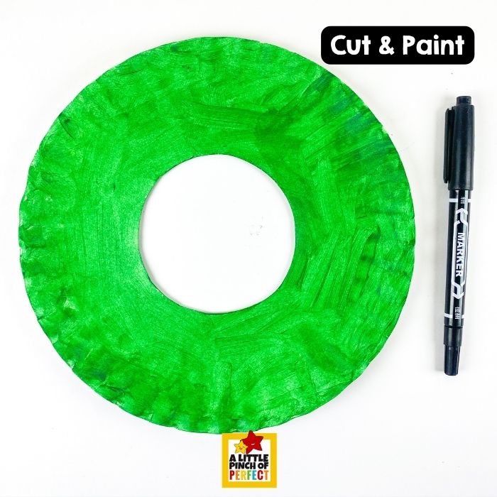 Back to School Paper Plate Crayon Wreath Craft and Template &ndash; Painting a paper plate green creates the colorful wreath base for this first day of school activity.